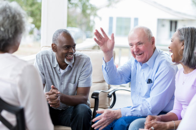 A group of older Floridians enjoy great conversation with no issues due to hearing aids.